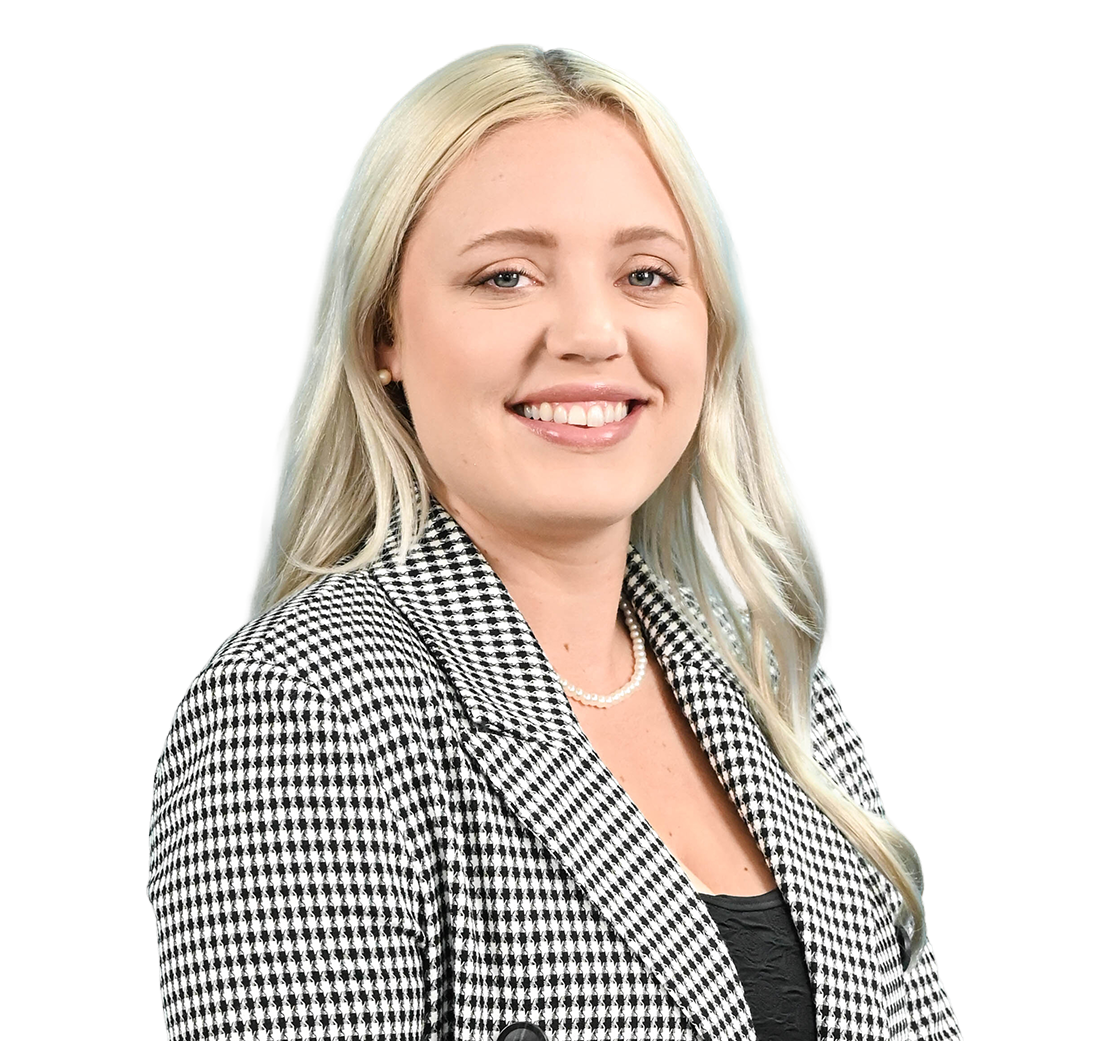 Smiling professional in a black-and-white checkered blazer against a white background
