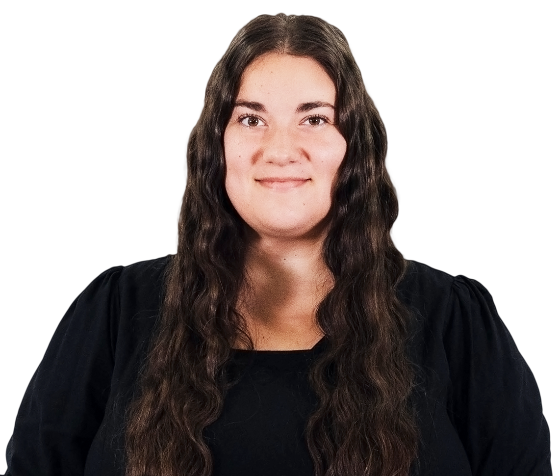 Portrait of a person with long dark wavy hair wearing a black top against a white background
