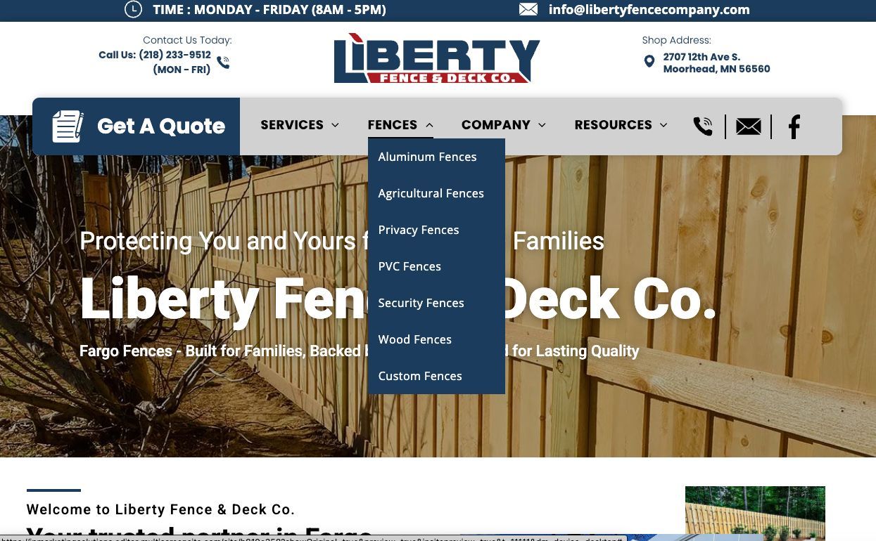 Liberty Fence & Deck Co. website homepage with blue navigation and a wooden fence hero image
