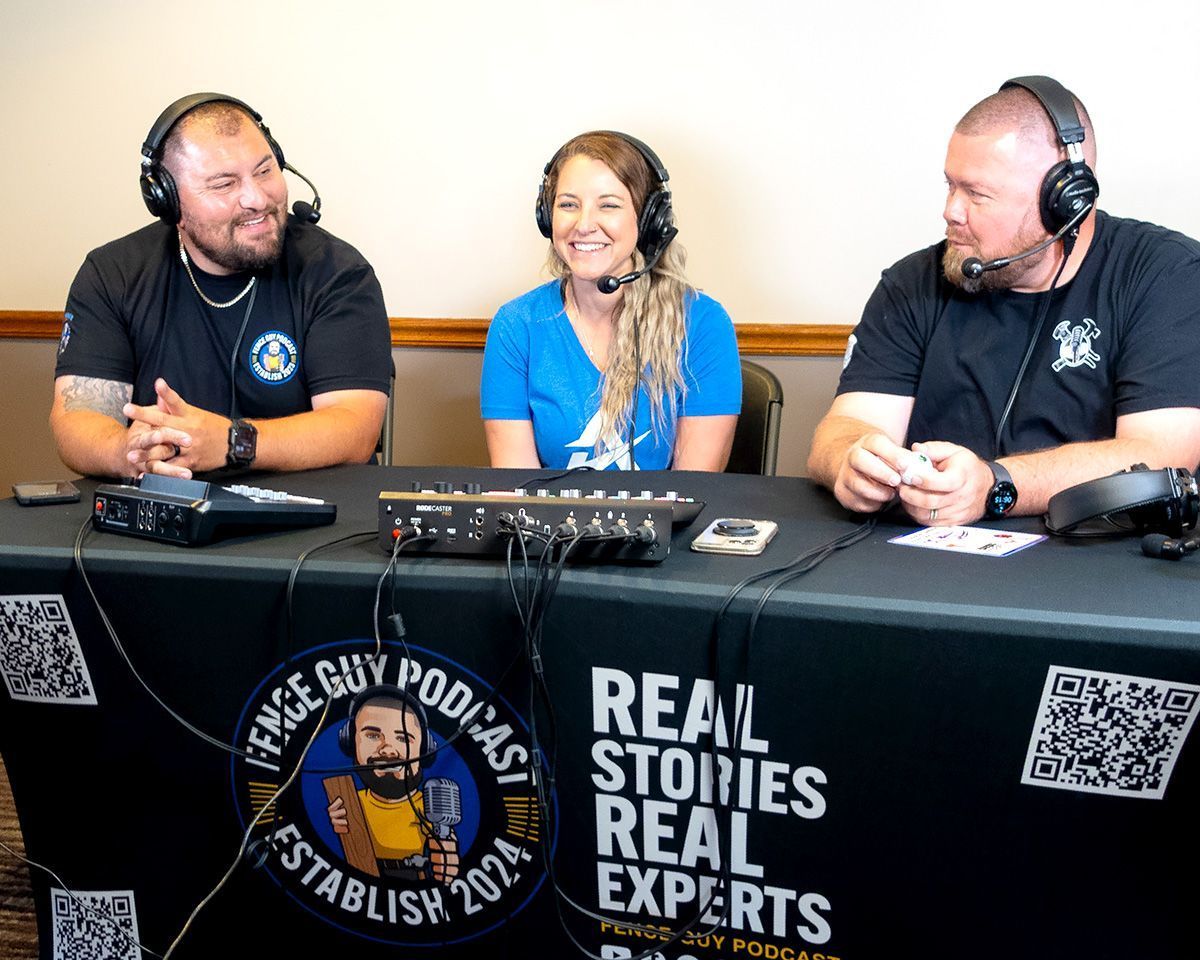 Three podcast hosts wearing headphones seated behind a table with microphones and “Real Stories Real Experts” banner