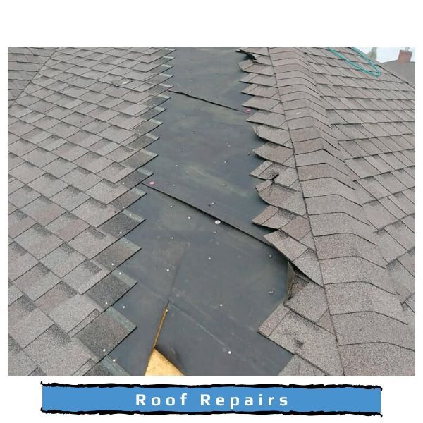 Roof shingles removed from a valley, exposing the dark underlayment, as part of a roof repair.