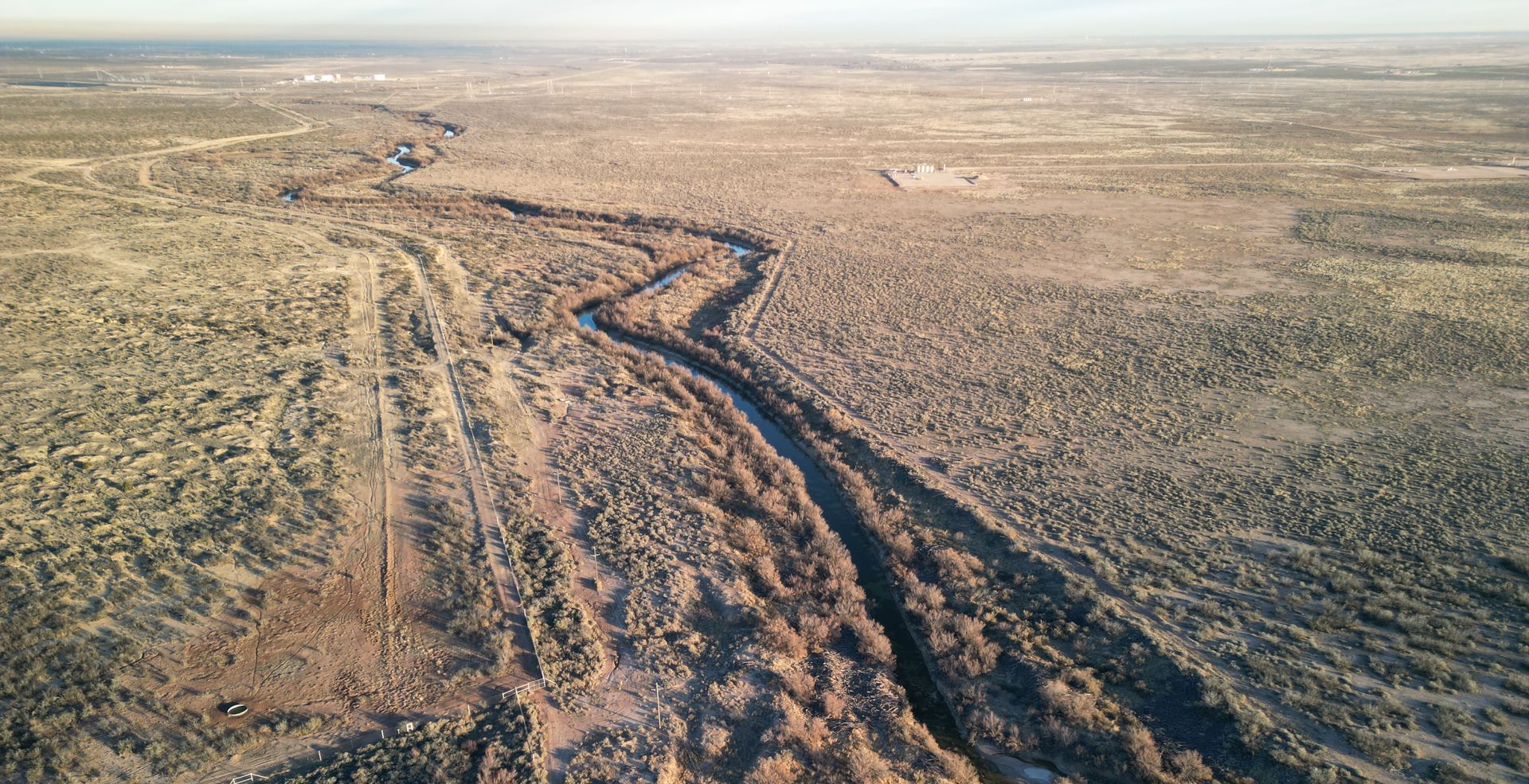 An aerial view of a dirt road in the desert