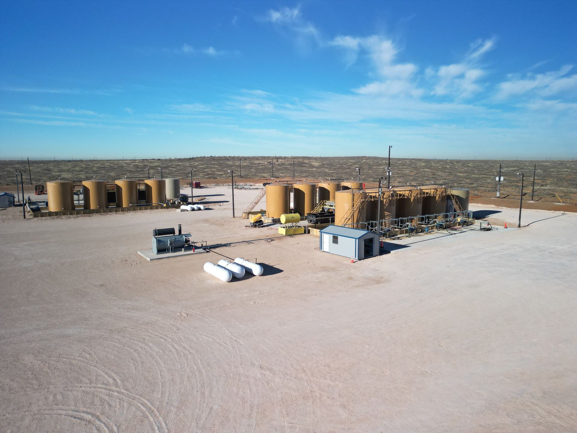 An aerial view of a field with a lot of tanks