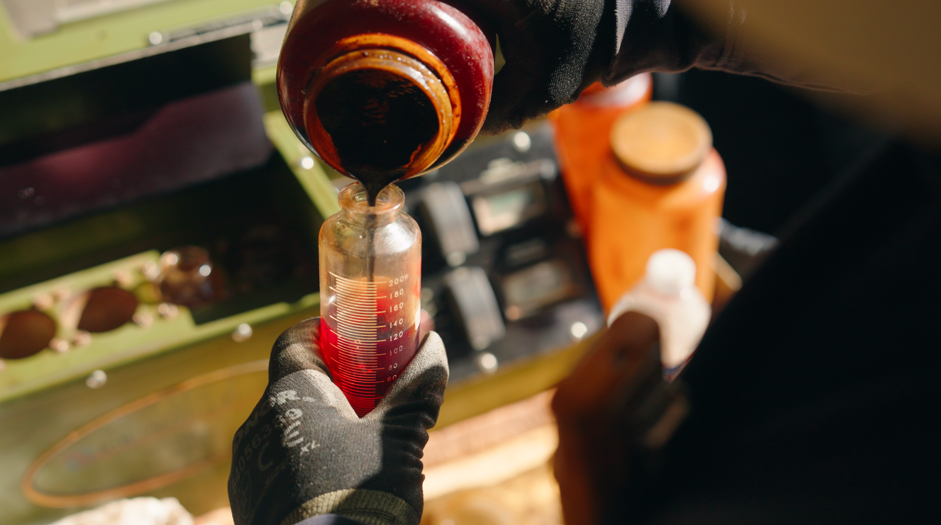 A person is pouring liquid into a measuring cup.