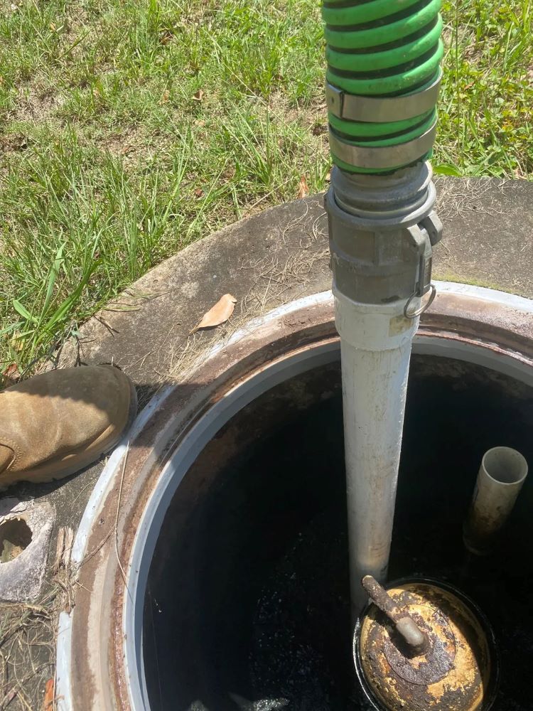 A Person Is Pumping Water Into A Septic Tank — Tweed Valley Septics & Liquid Waste Management in Bilambil, NSW