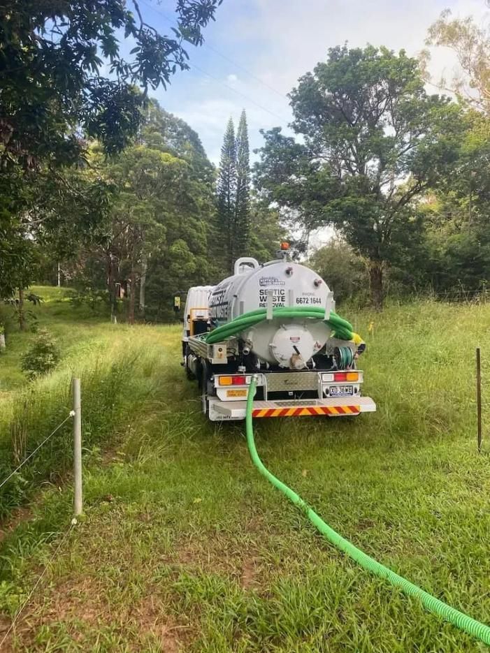 Vacuum Truck is Parked in a Grassy Field — Tweed Valley Septics & Liquid Waste Management in South Murwillumbah, NSW