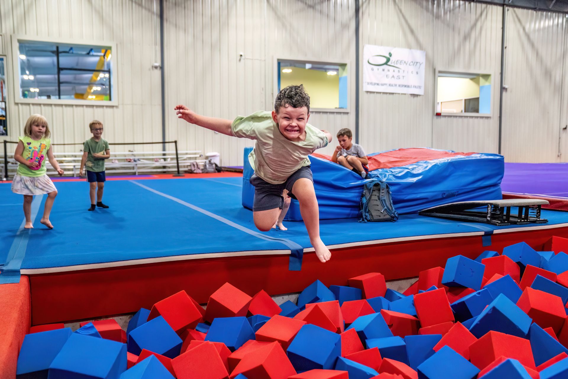 boy jumping into a foam pit at Kids First Too