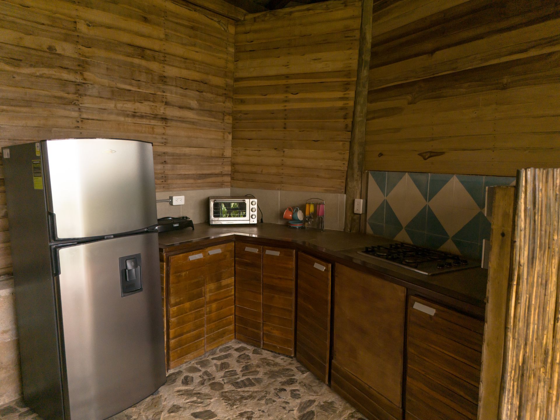 A kitchen with a refrigerator , microwave , and stove.