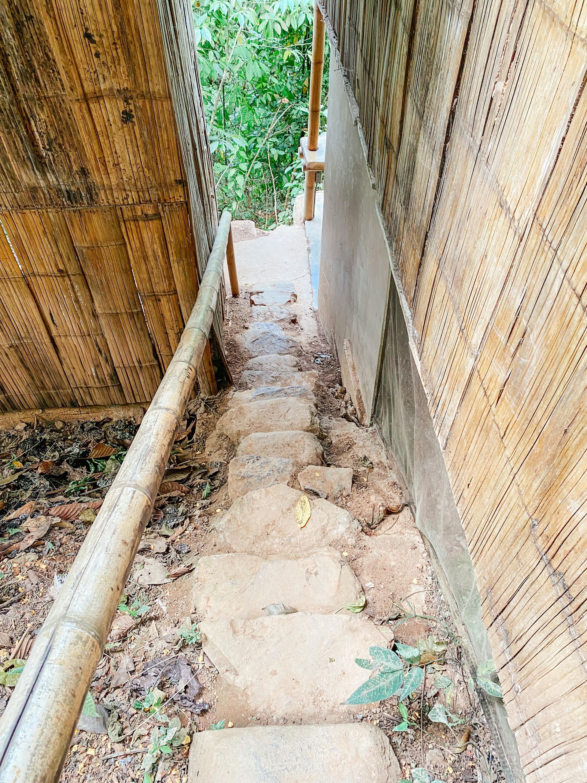 A set of stone stairs leading up to a wooden building.