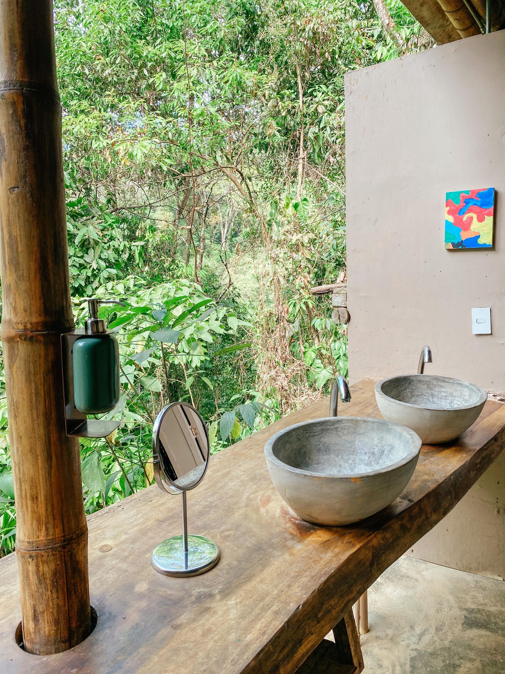 A bathroom with two sinks and a mirror on a wooden counter.