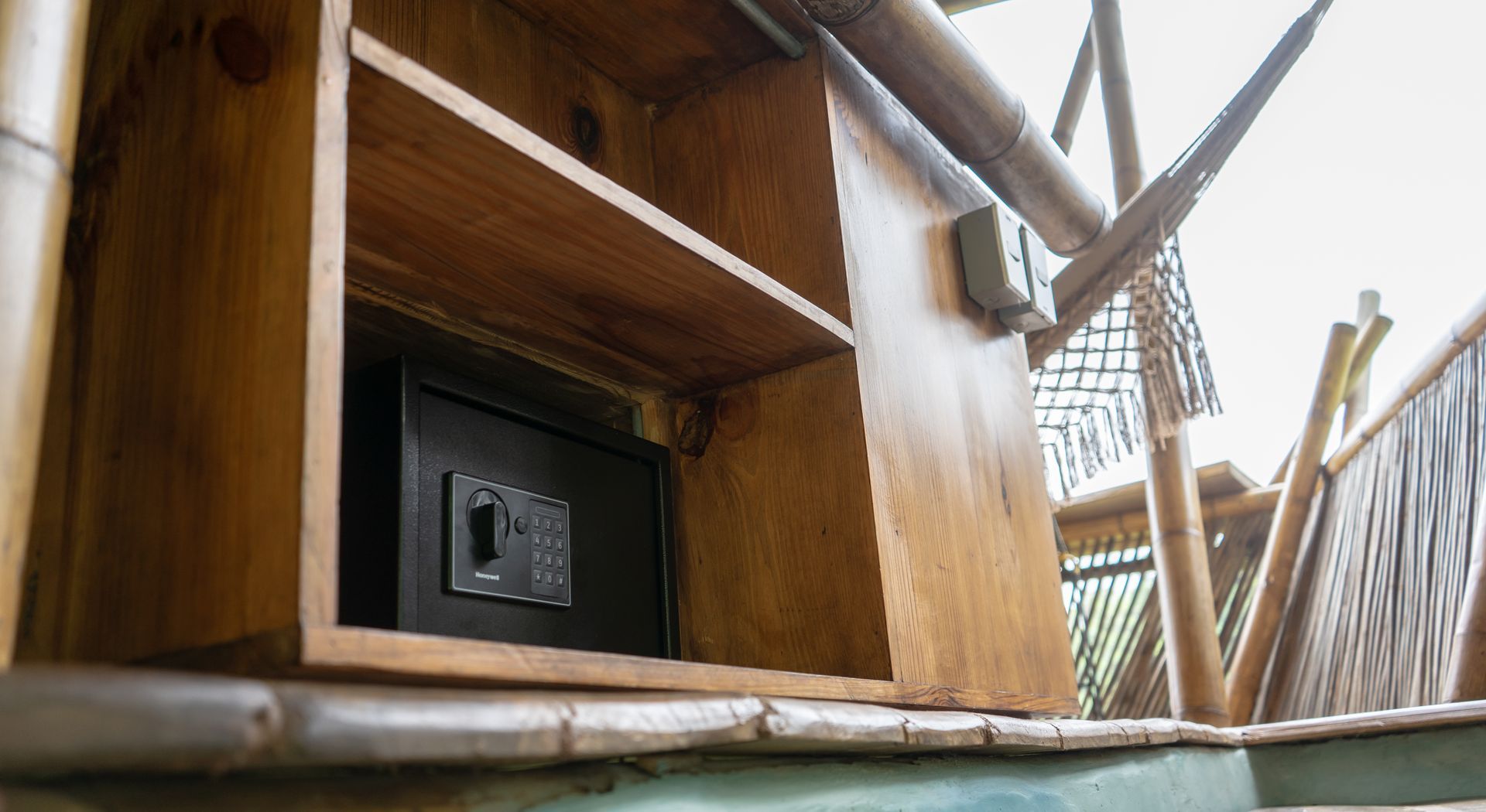 A wooden shelf with a safe inside of it.