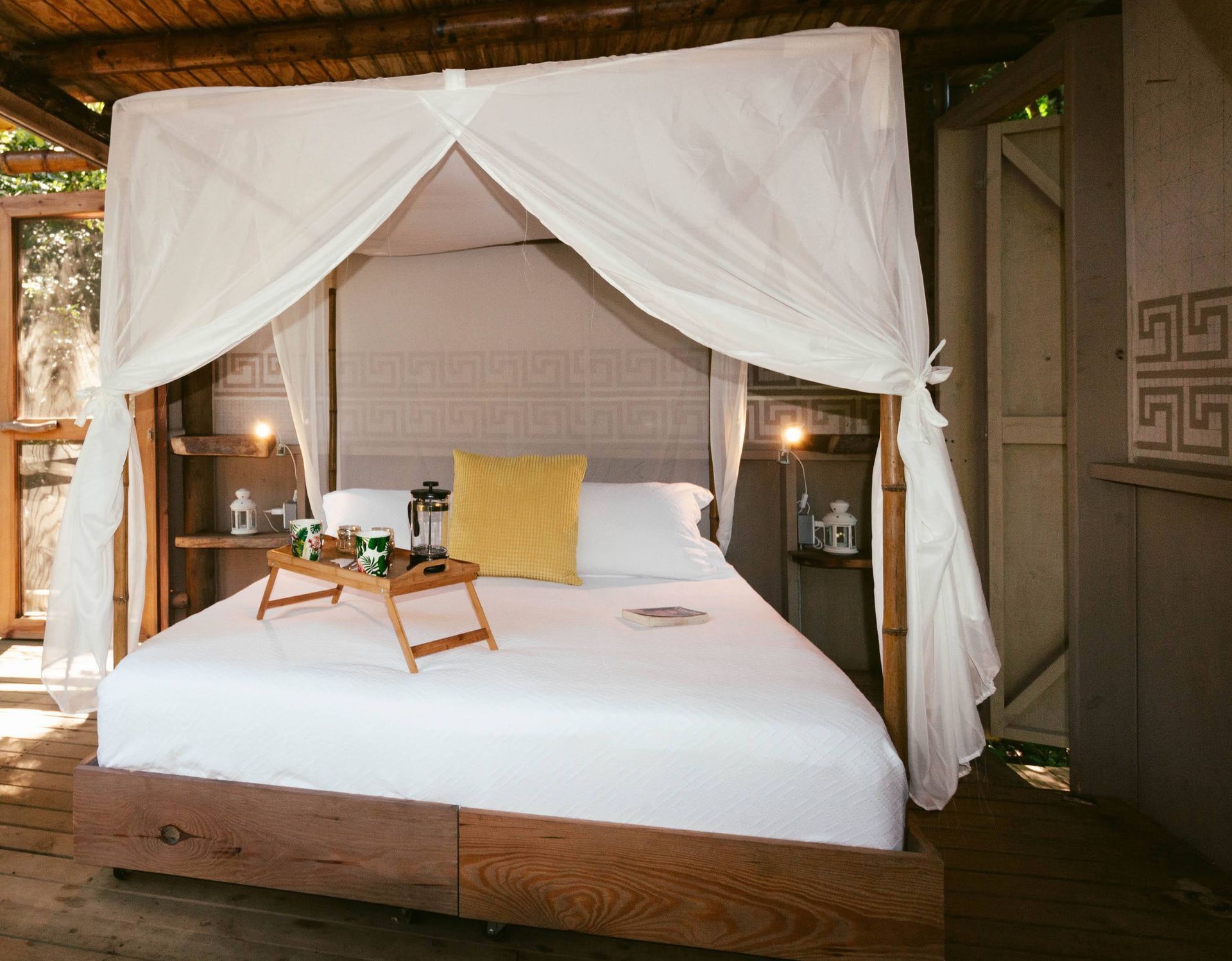A bed with a canopy and a tray on it