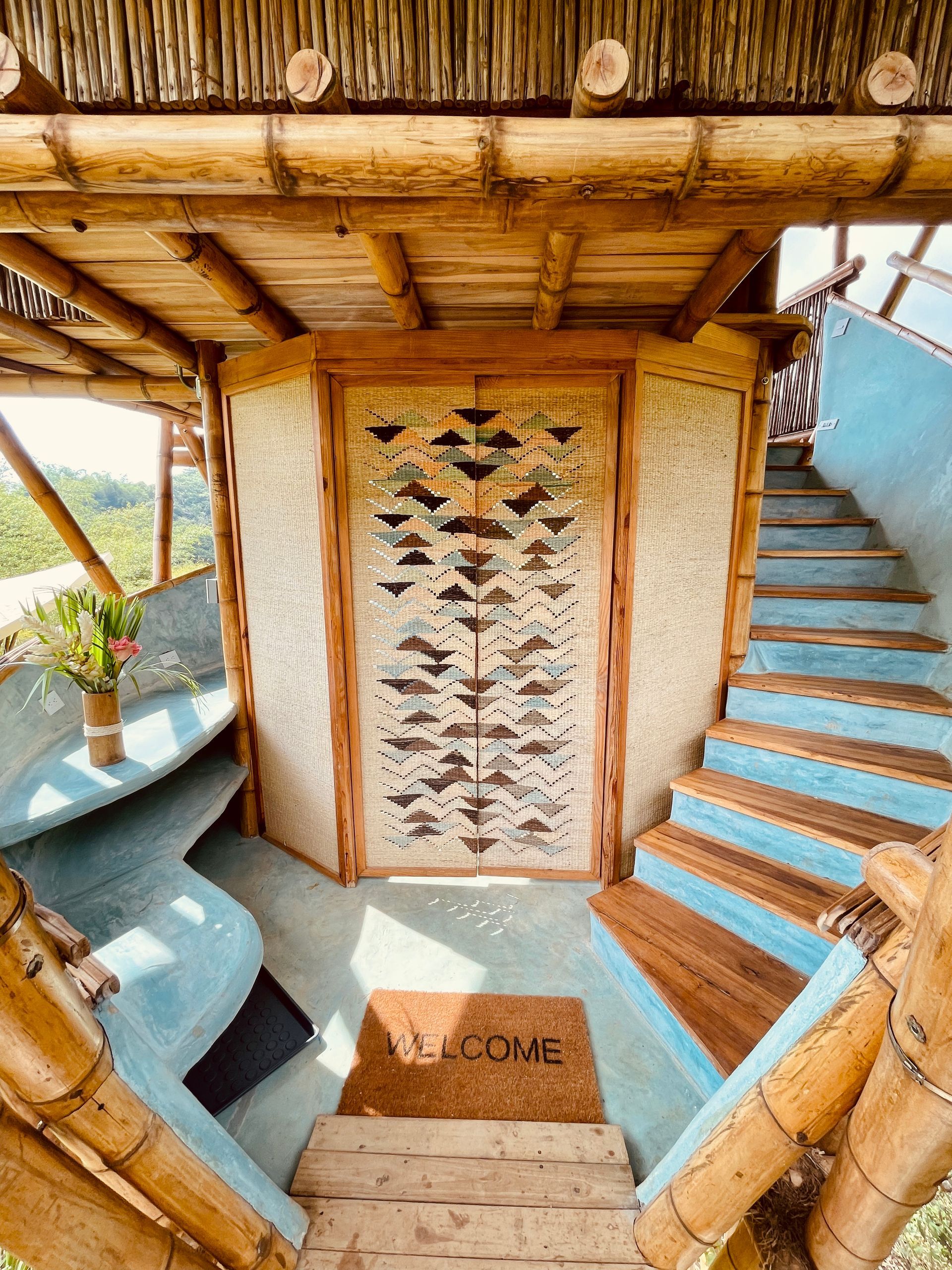 The stairs are made of bamboo and the door is made of wood.