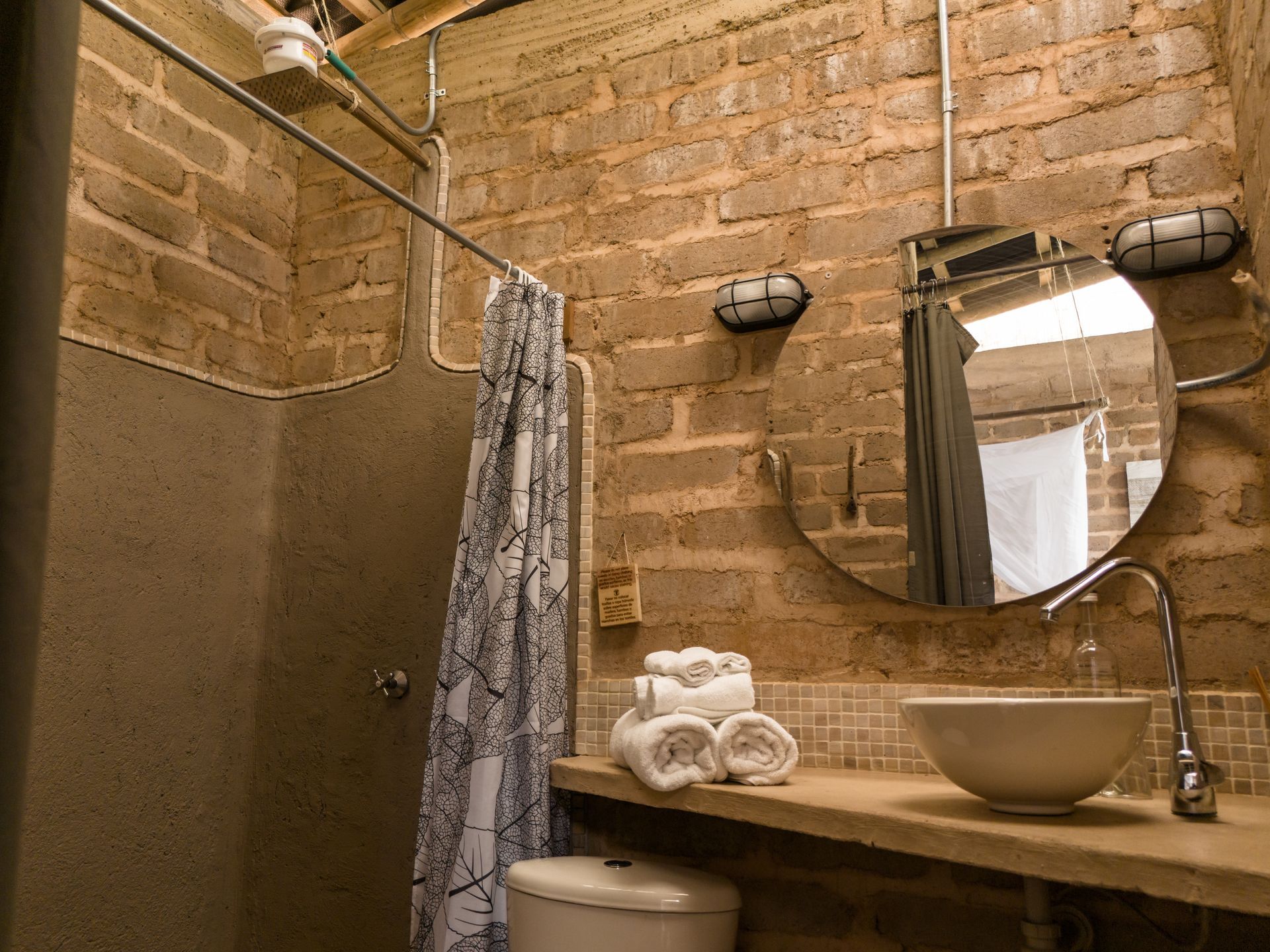 A bathroom with a toilet a sink and a mirror