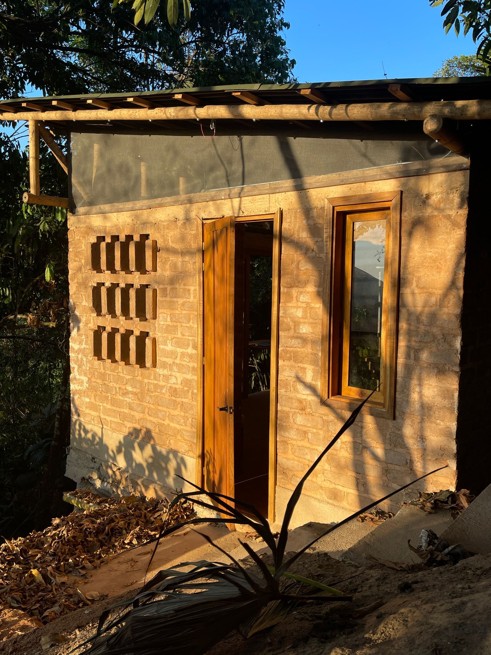 A brick building with a wooden door and window