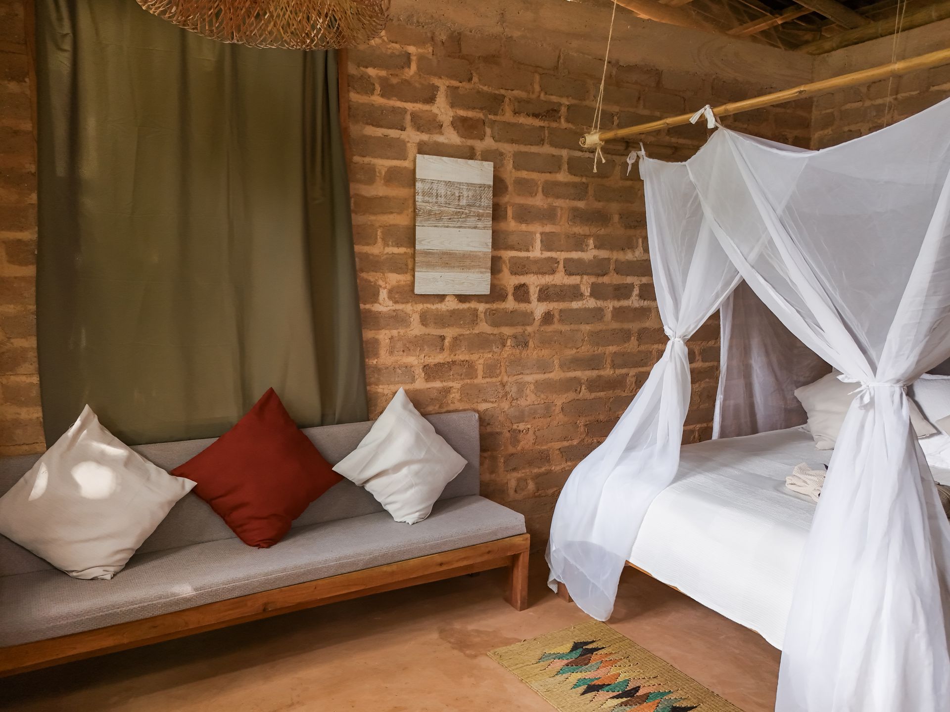 A bedroom with a canopy bed and a couch