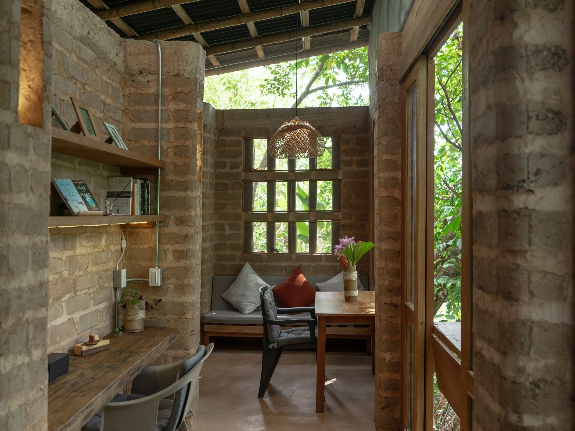 A room with a table and chairs and a brick wall