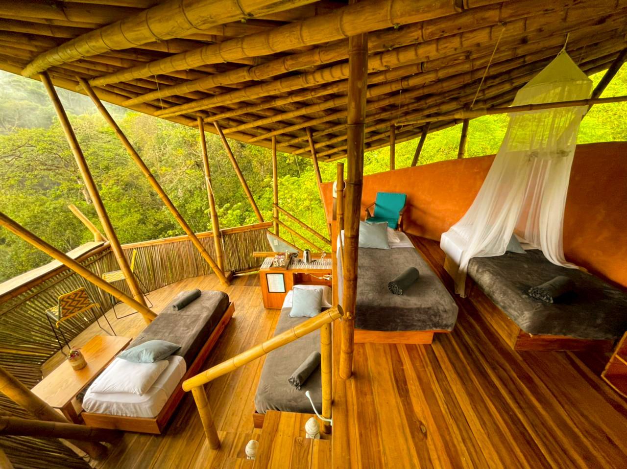 A room with two beds and a canopy bed in it