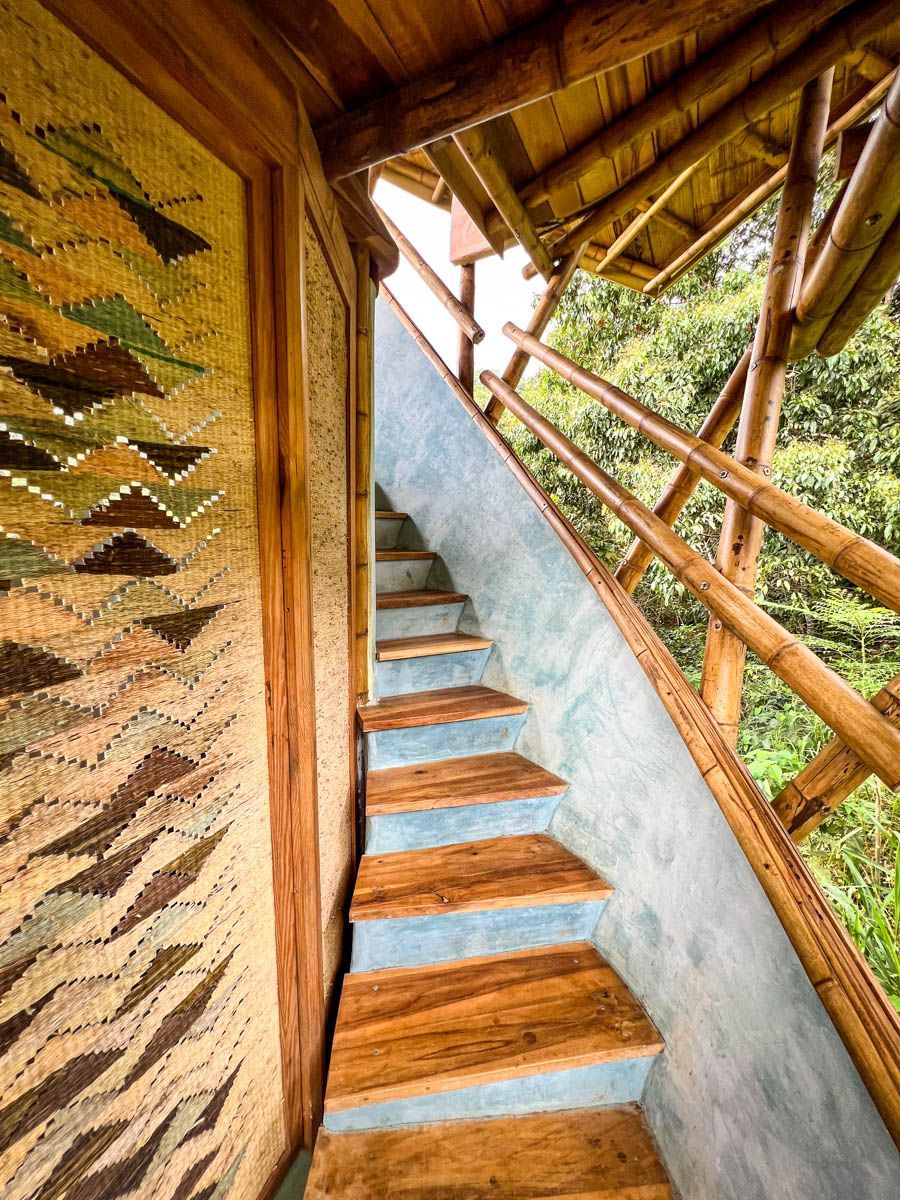 A set of wooden stairs leading up to a balcony