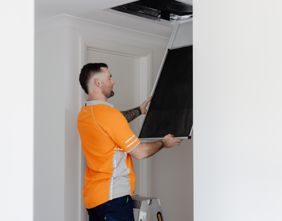 Win Air & Electrical team member carrying a vent to install.