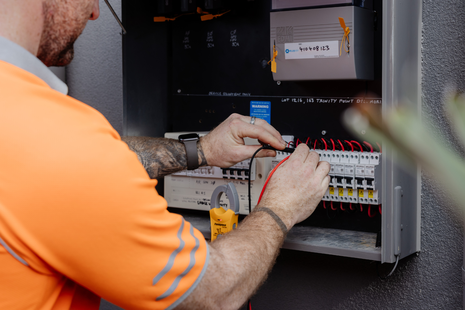 Win Air & Electrical team member fault fixing an electrical switch board.