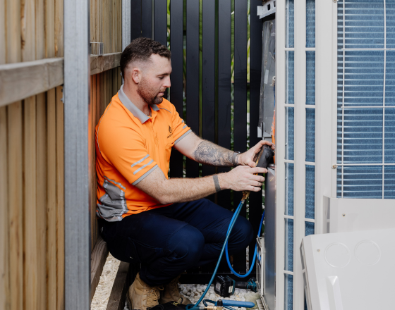 Win Air & Electrical team member conducting electrical work outside of an clients home.