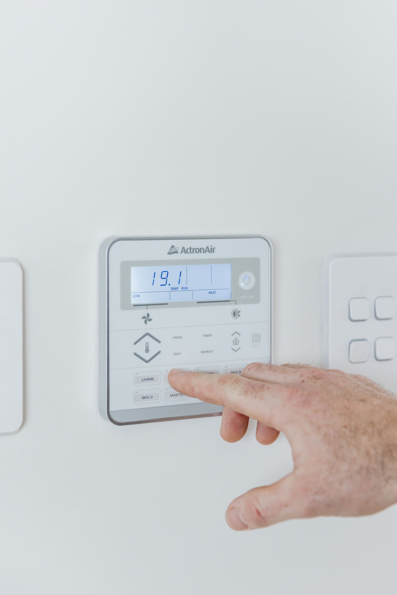 Ducted air conditioning touch control pad installed in a modern Newcastle home living room