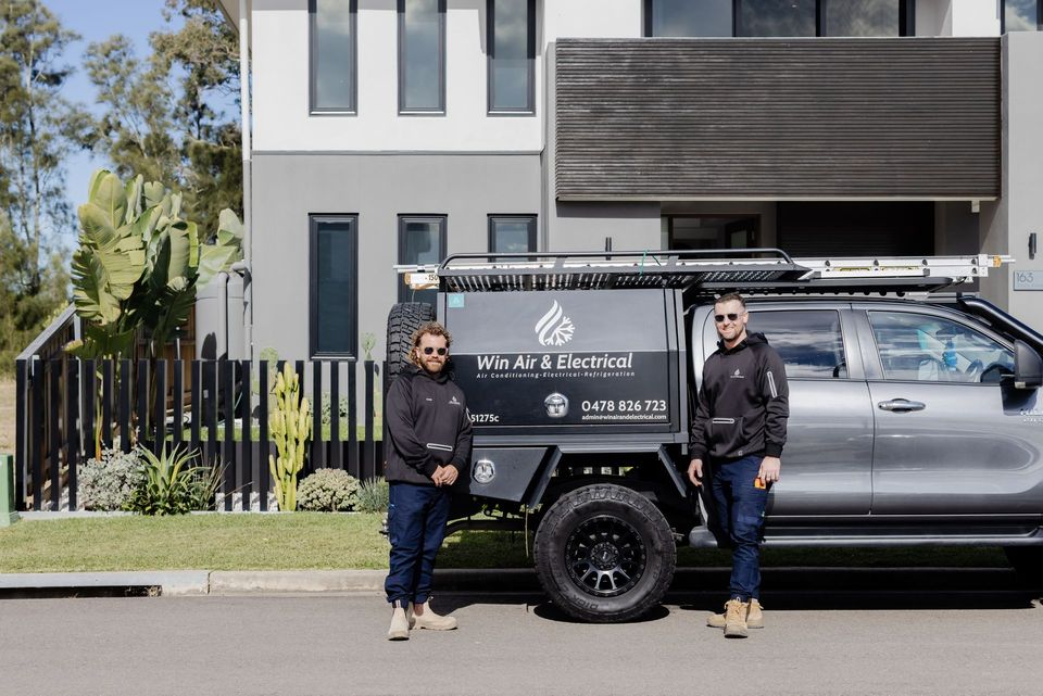 Win Air & Electrical team members standing in-front of work vehicle.