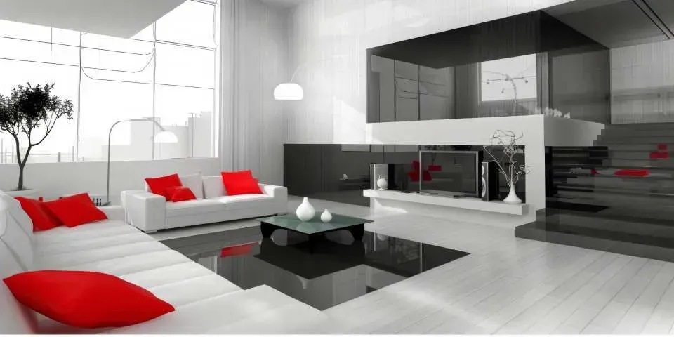 Modern white living room with red cushions, black glass table, and open kitchen area