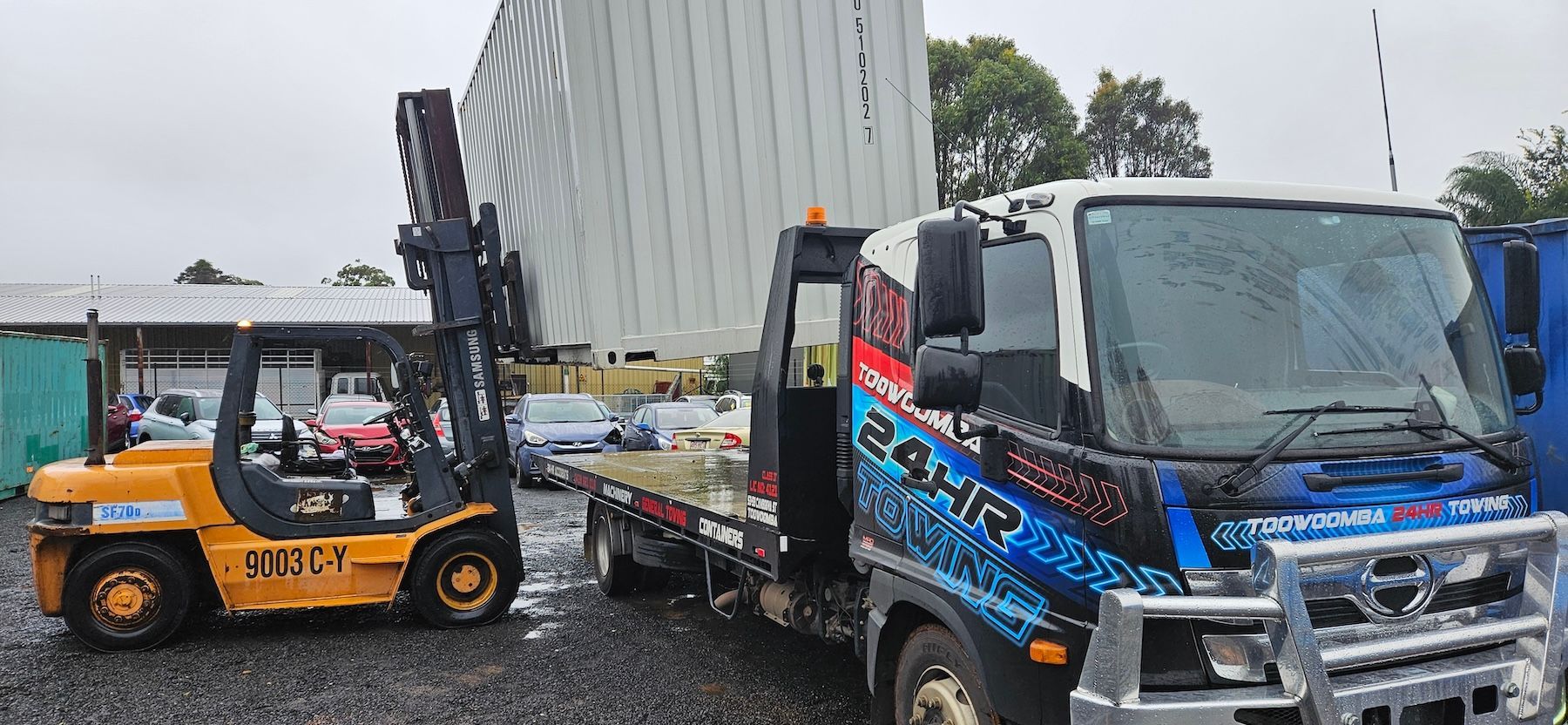 Tow Truck is Towing a Blue and White Car — Toowoomba 24hr Towing in Murphys Creek, QLD