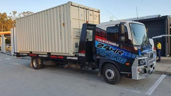 Tow Truck is Towing a Shipping Container in a Parking Lot — Toowoomba 24hr Towing In Toowoomba, QLD