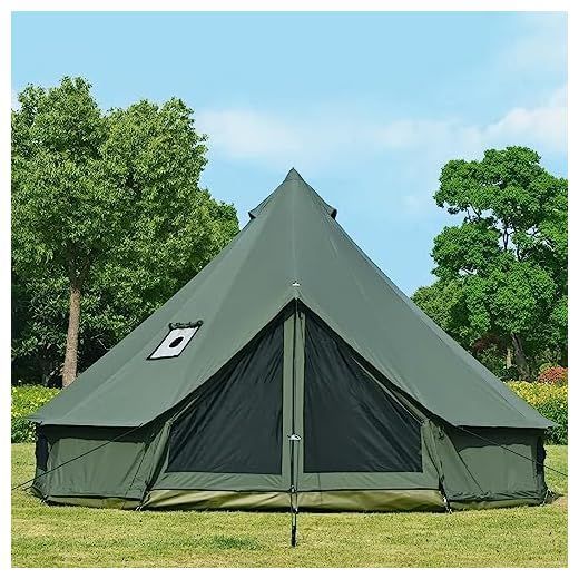 Large green camping tent on grass with trees and blue sky in the background