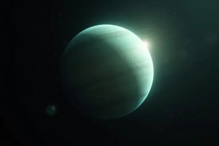 A pale green planet floating in dark space with a soft glow on its right side.