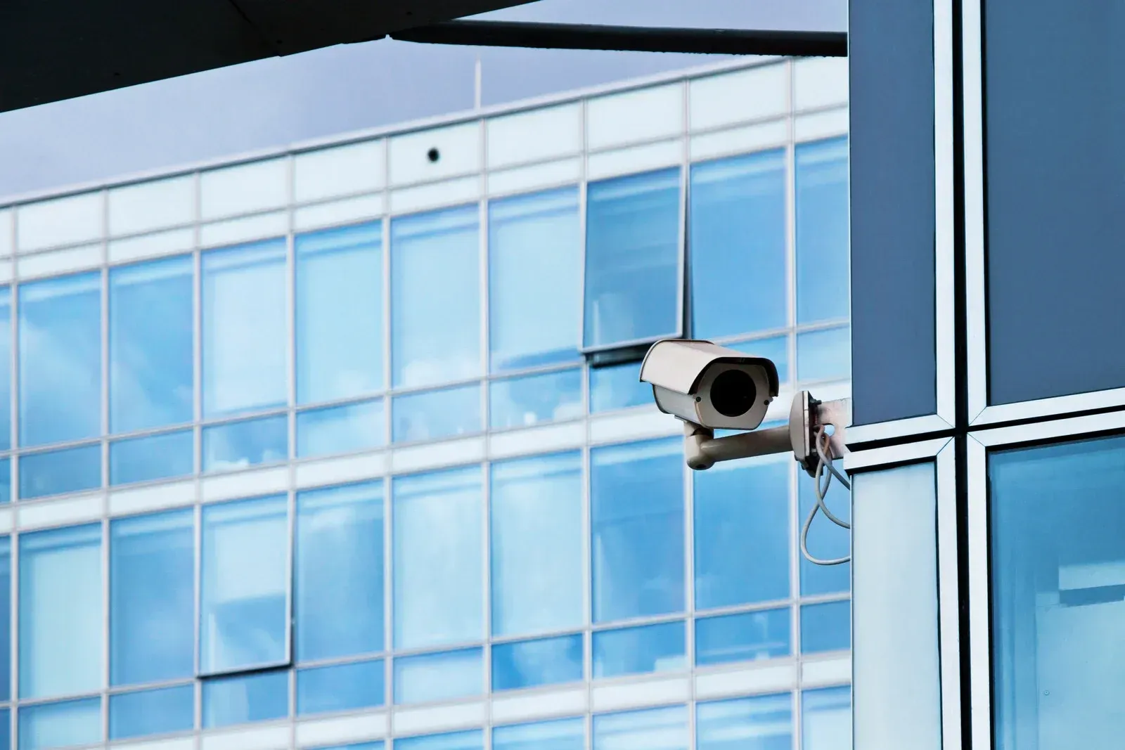 A security camera is mounted on the side of a building