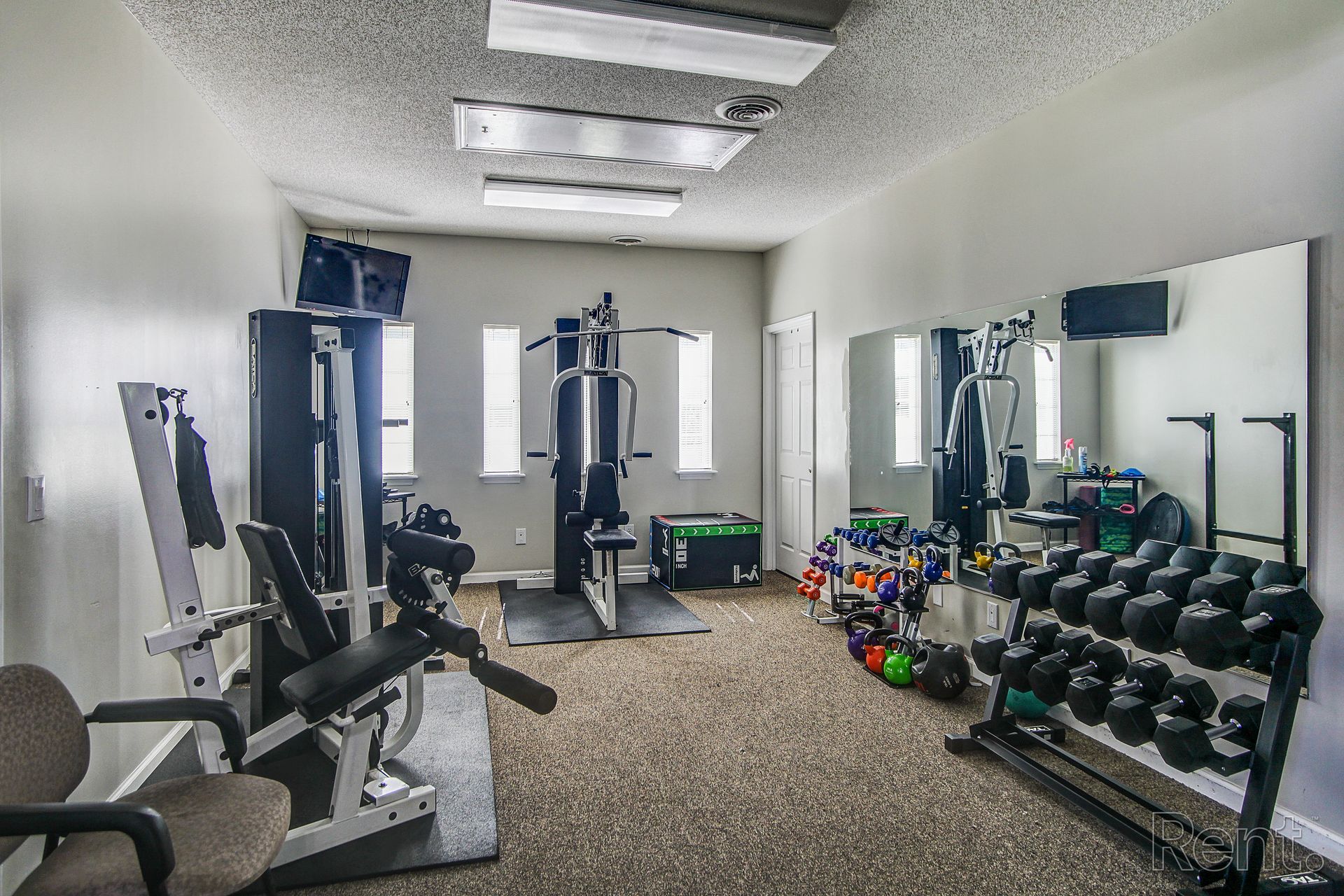 Meridian Park Clubhouse- Fitness Center- View of workout equipment for body strength (shoulders, back, legs) and free weights