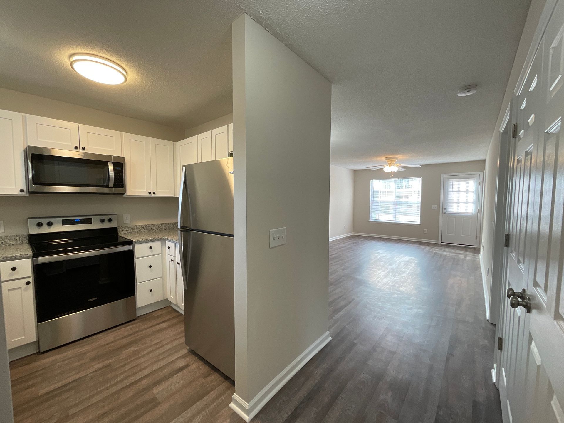 crest remodeled kitchen with partial view of the living area and back door. 