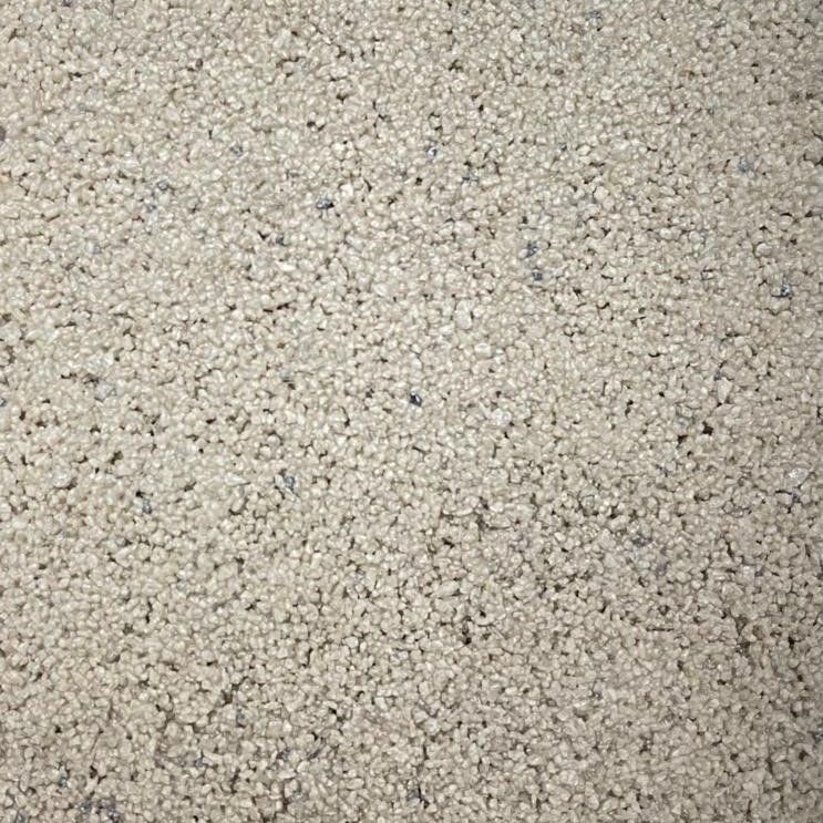 Close-up of light gray gravel with small, speckled dark inclusions.