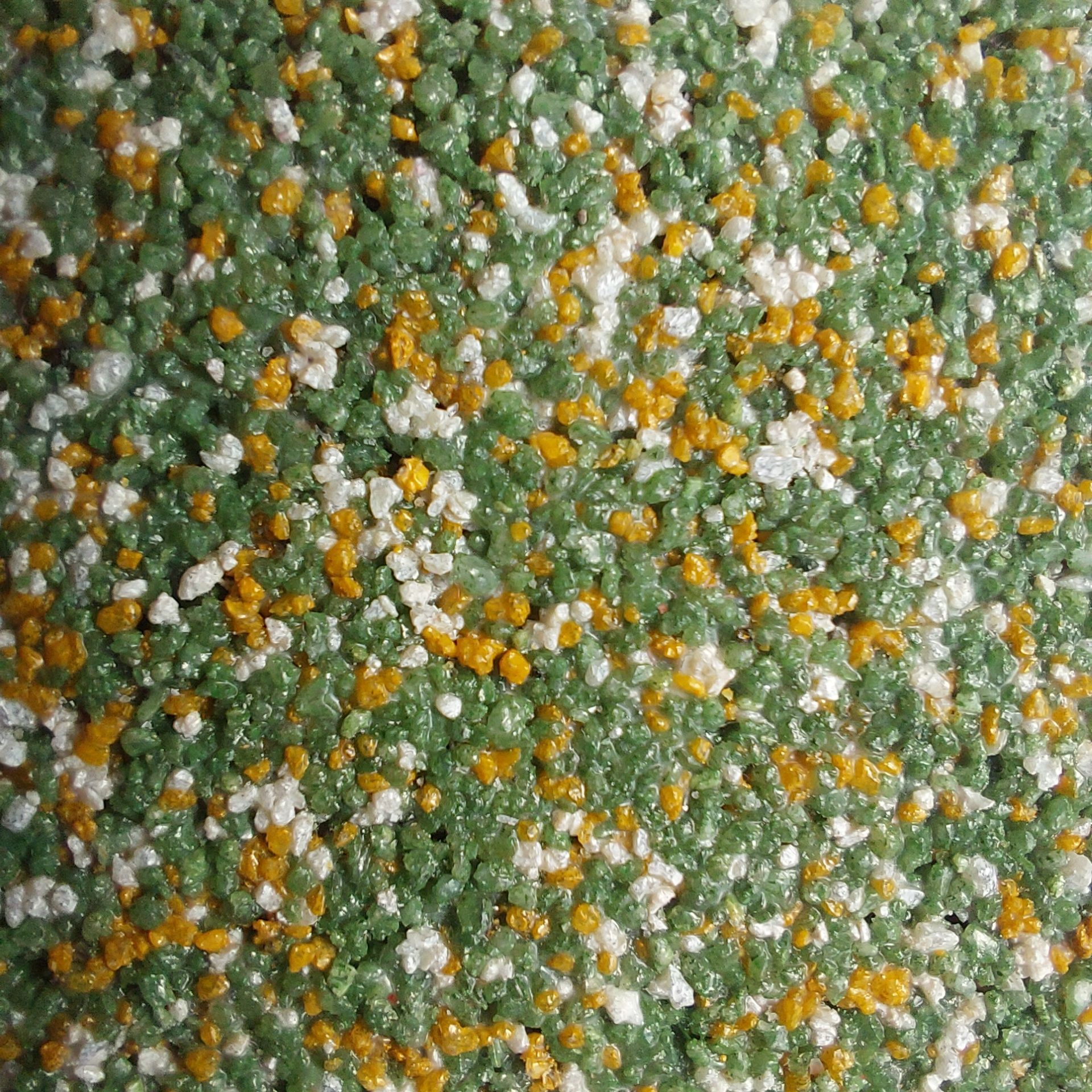 Green, white, and yellow speckled textured surface.