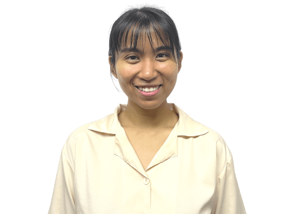 Smiling woman with dark hair and bangs wearing a light yellow shirt, against a white background.