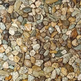 Close-up of small, colorful pebbles in various earthy tones and shapes.