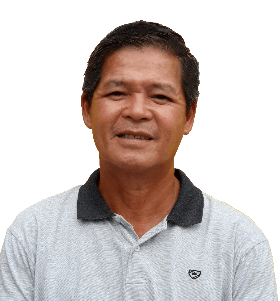 Man in a gray polo shirt smiles at the camera, against a white background.