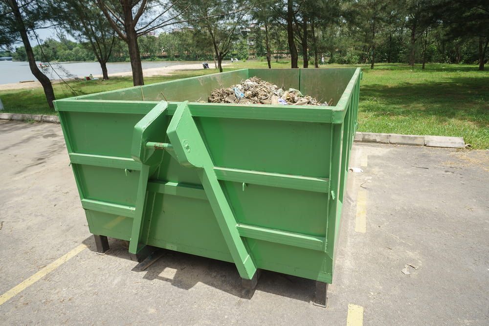Skip Bin Filled With Rubbish in a Parking Lot — Handi Skips in Bohle, QLD