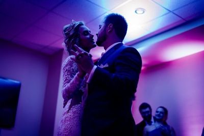 Couple dancing during wedding reception with DJ lighting in Calgary