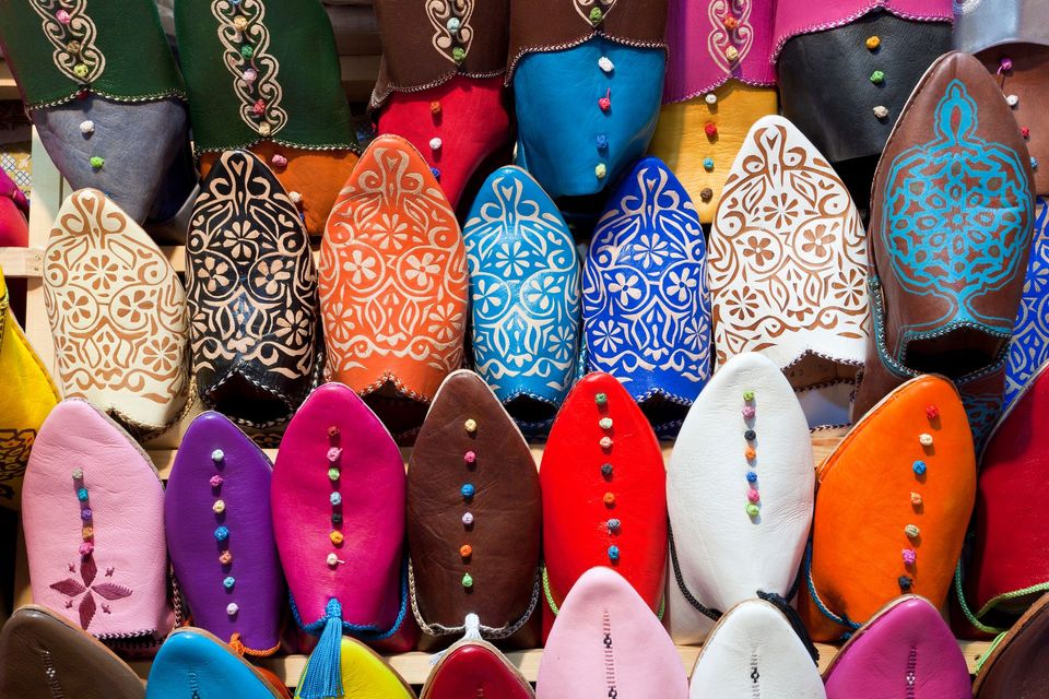 A bunch of colorful shoes are lined up on a table