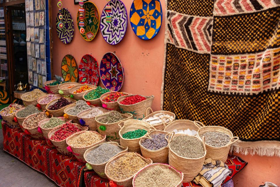 A table full of baskets filled with different types of spices
