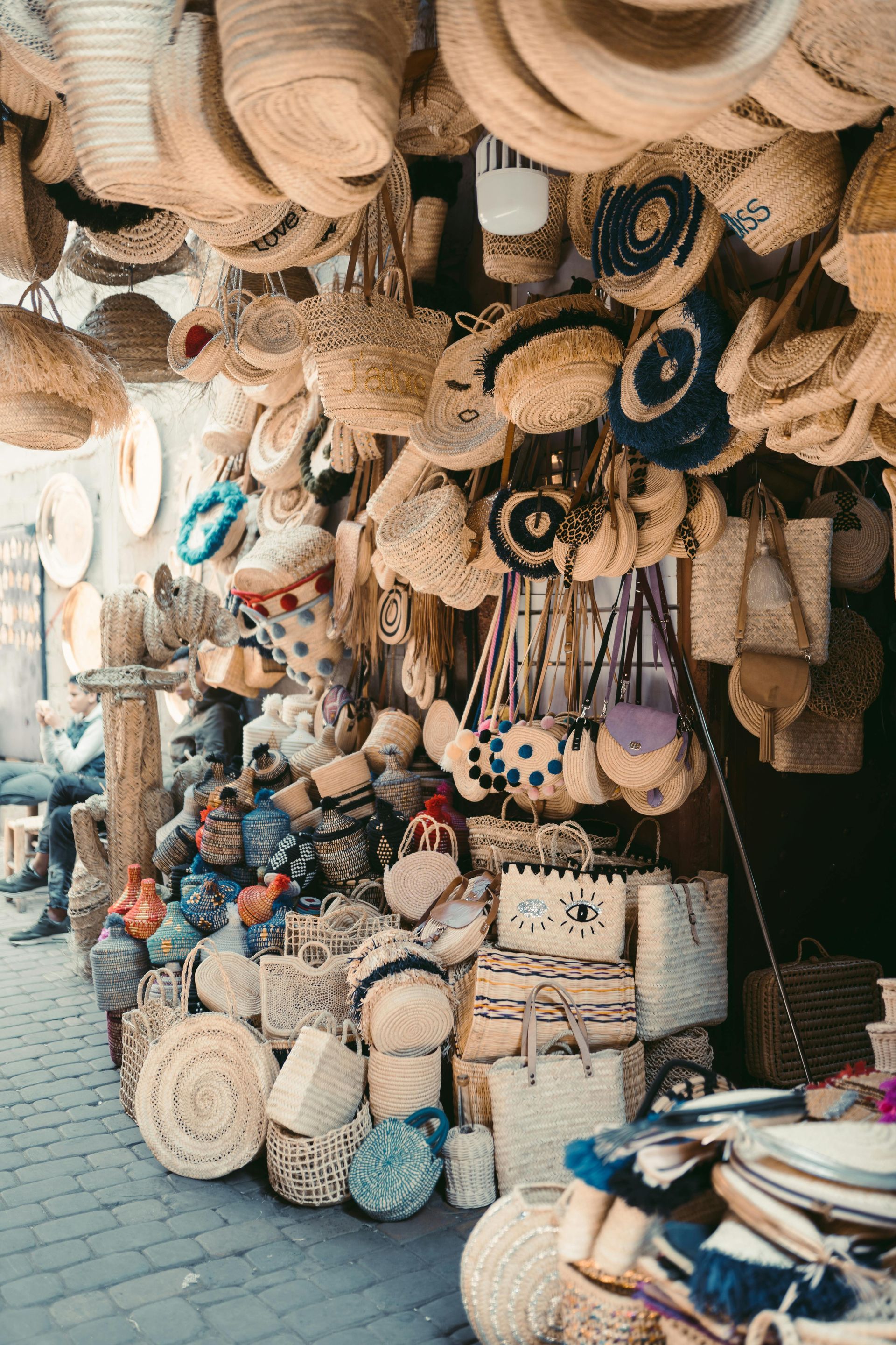 A bunch of baskets and hats are hanging from the ceiling of a store.