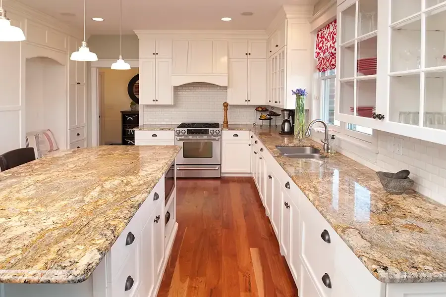 Bright white kitchen with granite countertops, stainless stove, hardwood floor, and red window valance