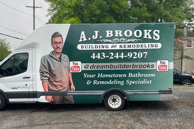 A.J. Brooks home remodeling van with company logo, phone number, and contractor portrait on the side