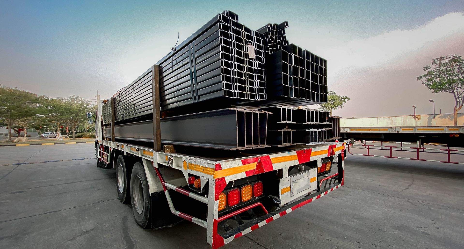 A Truck is Carrying a Stack of Black Pipes — Supersonic Couriers In Moranbah, QLD