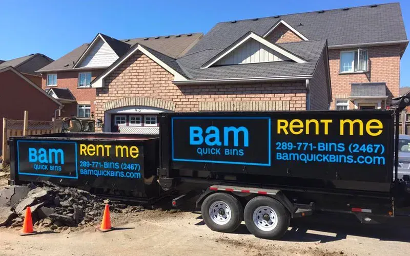 A black dumpster trailer with the words 